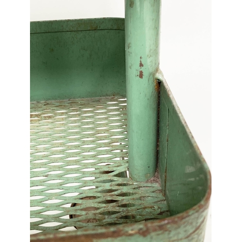 219 - WORKSHOP TROLLEYS, a pair, mid 20th century original green painted metal each with three tiers (on c... 