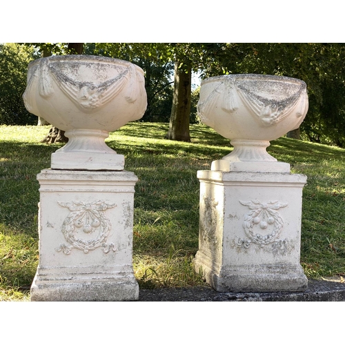 222 - GARDEN URNS, a pair, well weathered reconstituted stone with swag detail and similarly decorated pli... 