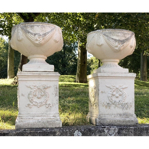 222 - GARDEN URNS, a pair, well weathered reconstituted stone with swag detail and similarly decorated pli... 