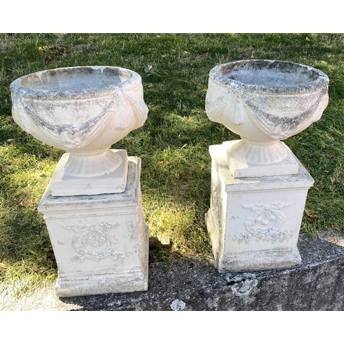 222 - GARDEN URNS, a pair, well weathered reconstituted stone with swag detail and similarly decorated pli... 