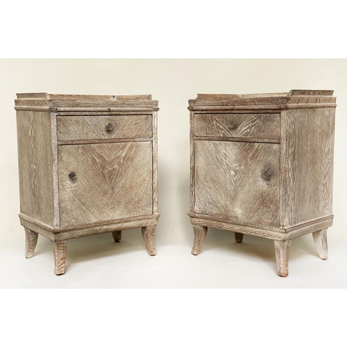 254 - BEDSIDE CHESTS, a pair, mid 20th century limed oak each galleried with mirror top, drawer and cupboa... 