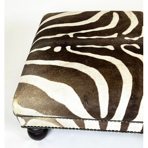 326 - ZEBRA SKIN FOOTSTOOL, rectangular studded zebra hide upholstered on turned wooden supports, 43cm H x... 