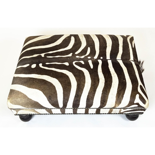 326 - ZEBRA SKIN FOOTSTOOL, rectangular studded zebra hide upholstered on turned wooden supports, 43cm H x... 