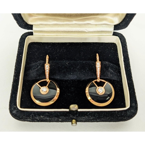 36 - A PAIR OF AMULETTE DE CARTIER 18CT GOLD DIAMOND SET EARRINGS, each set with a central round brillian... 