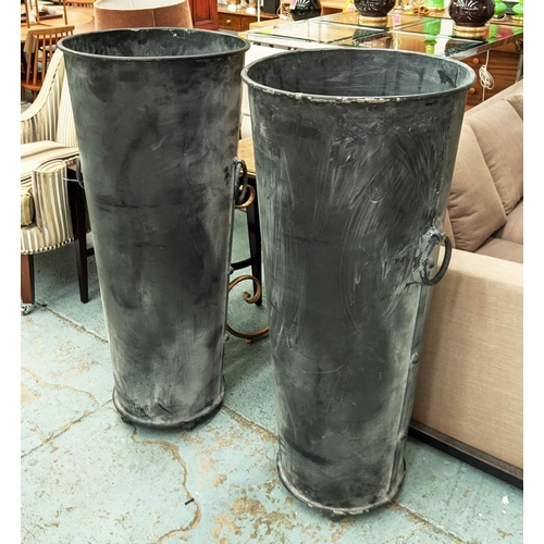 317 - TALL PLANTERS, a pair, 119cm x 53cm diam. each, aged metal, with ring handle detail and ball feet. (... 