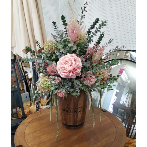 313 - FAUX FLORAL DISPLAY, 100cm H, in a vessel stamped Bollinger Champagne.