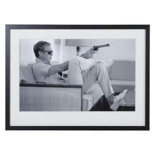 302 - AFTER JOHN DOWNING, Steve McQueen with a gun, photographic print, framed and glazed, 54cm x 74cm.