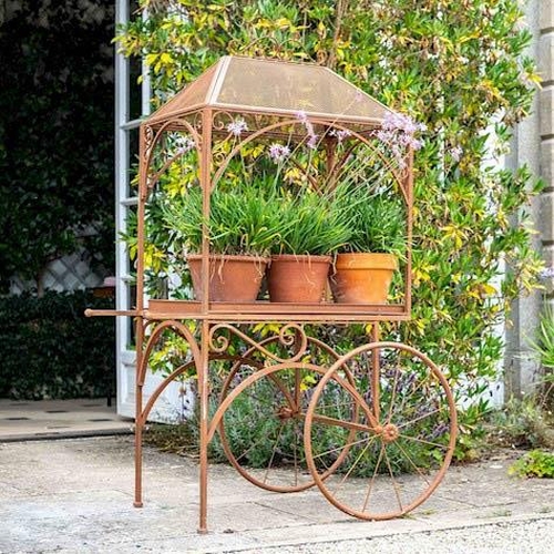 303 - PLANT STAND, 152cm x 98cm x 70cm, in the form of a vintage cart, oxidised metal finish