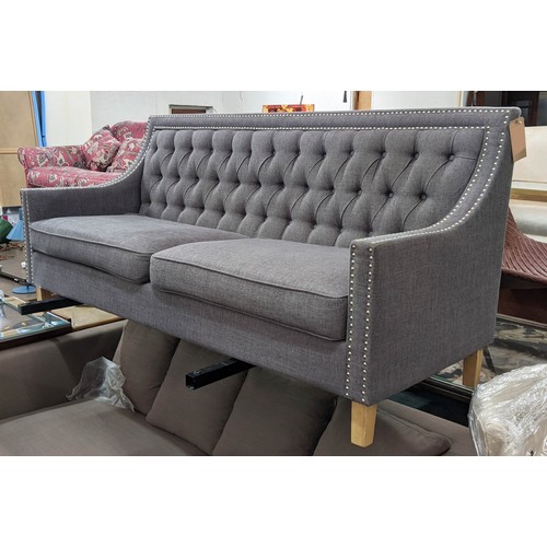 418 - SOFA, 194cm L x 90cm H with a buttoned back, studded decoration and grey upholstery.