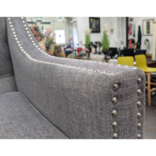 418 - SOFA, 194cm L x 90cm H with a buttoned back, studded decoration and grey upholstery.