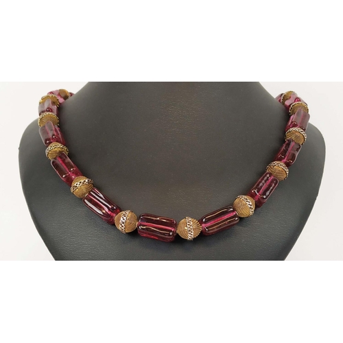 11 - BEAD NECKLACE, believed to be Shakira Caine for Harrods, single strand with ruby coloured oblong squ... 