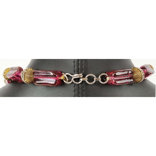 11 - BEAD NECKLACE, believed to be Shakira Caine for Harrods, single strand with ruby coloured oblong squ... 