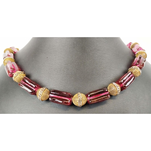 11 - BEAD NECKLACE, believed to be Shakira Caine for Harrods, single strand with ruby coloured oblong squ... 