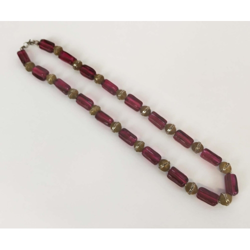 11 - BEAD NECKLACE, believed to be Shakira Caine for Harrods, single strand with ruby coloured oblong squ... 