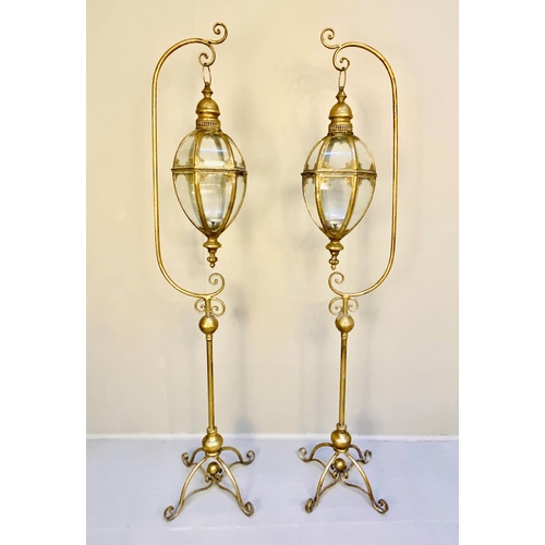 470 - STORM LANTERNS ON STANDS, a pair, 163cm high, 35cm wide, Regency style, gilt metal. (2)