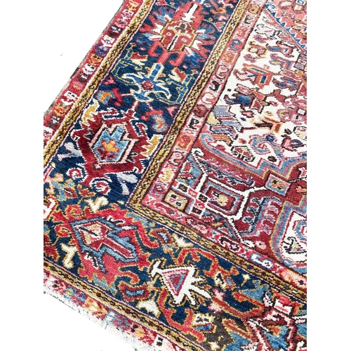 69 - ANTIQUE PERSIAN HERIZ CARPET, 330cm x 240cm.