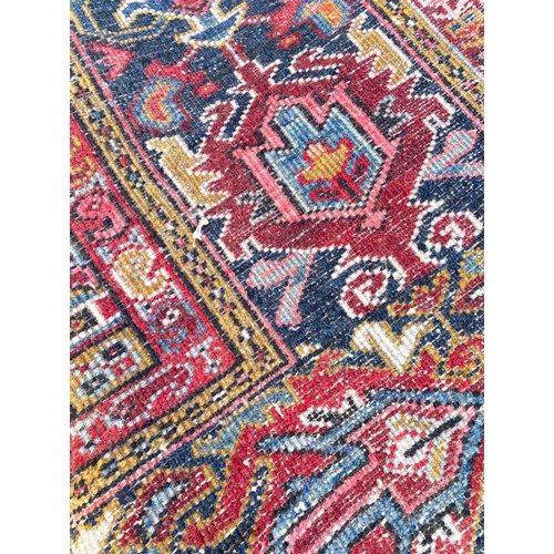 69 - ANTIQUE PERSIAN HERIZ CARPET, 330cm x 240cm.