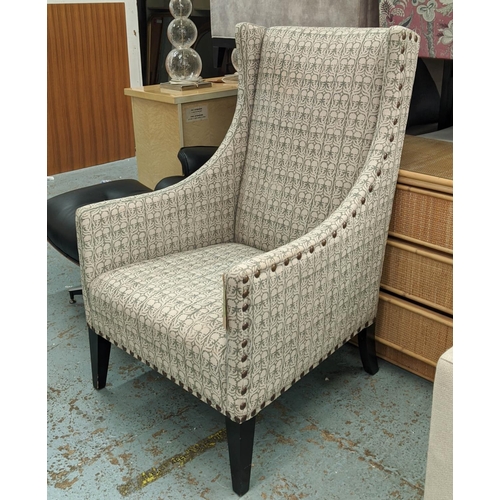 534 - ANDREW MARTIN LIBRARY CHAIR, 70cm x 116cm H, in a patterned linen fabric with studded detail.