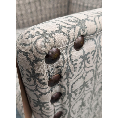 534 - ANDREW MARTIN LIBRARY CHAIR, 70cm x 116cm H, in a patterned linen fabric with studded detail.