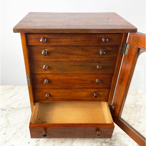 16 - COLLECTORS CABINET, Victorian mahogany with six graduated drawers behind arched glazed door on plint... 