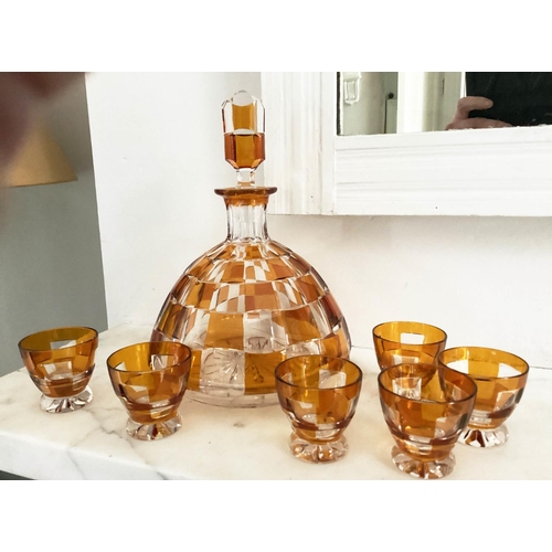 127 - DECANTER AND GLASSES, Art Deco Bohemian decanter and six glasses with amber overlaid glass detail de... 