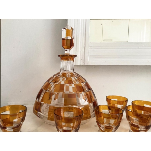 127 - DECANTER AND GLASSES, Art Deco Bohemian decanter and six glasses with amber overlaid glass detail de... 