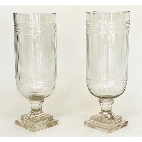 134 - STORM LANTERNS, a pair, cylindrical cut and engraved glass on stepped plinth bases, 40cm H. (2)