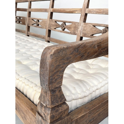 133 - BENCH, antique Anglo Colonial style teak with lattice back, down swept arms and later buttoned cushi... 