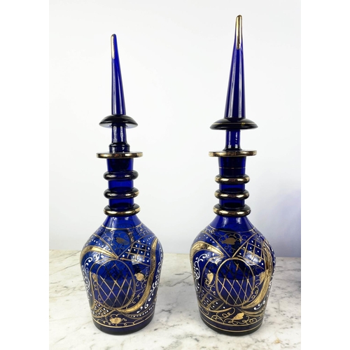 3 - BOHEMIAN DECANTERS, a pair, blue glass with gilt decoration and stoppers, two shaped lipped vases wi... 