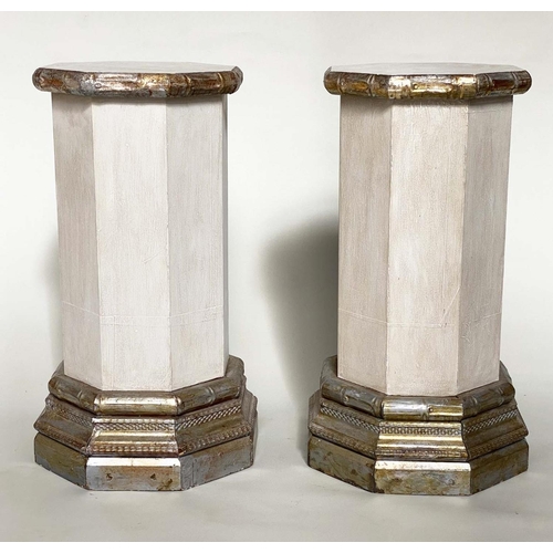 256 - COLUMNS/PLINTHS, a pair, octagonal grey painted, facetted with silvered wood, stepped plinths and ca... 