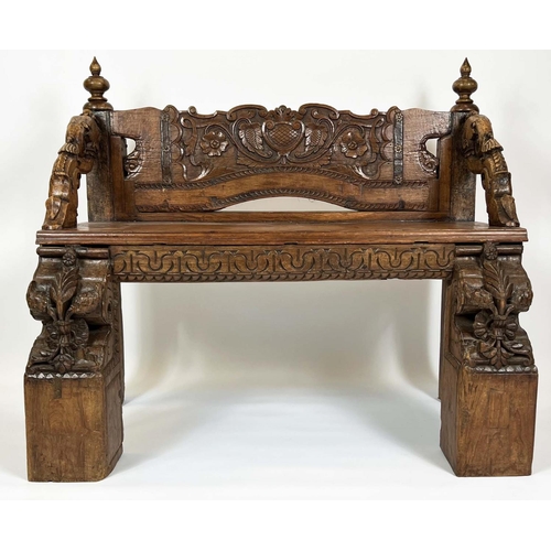 162 - RAJASTHANI BENCH, antique Indian hardwood, profusely carved with elephant head detail arms, 100cm H ... 