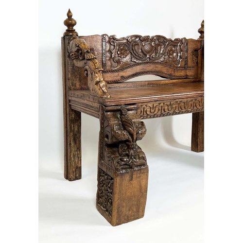 162 - RAJASTHANI BENCH, antique Indian hardwood, profusely carved with elephant head detail arms, 100cm H ... 