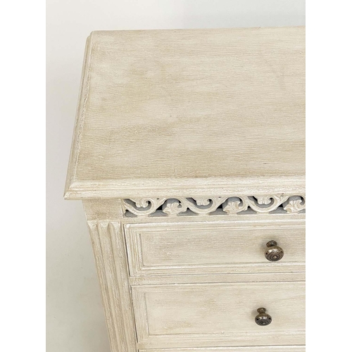 215 - COMMODE, French style traditionally grey painted with pierced frieze and four drawers, 75cm H x 89cm... 