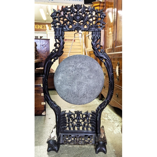 228 - CHINESE DINNER GONG, 65cm W x 127cm H 19th century ornately carved padoukwood with beater.