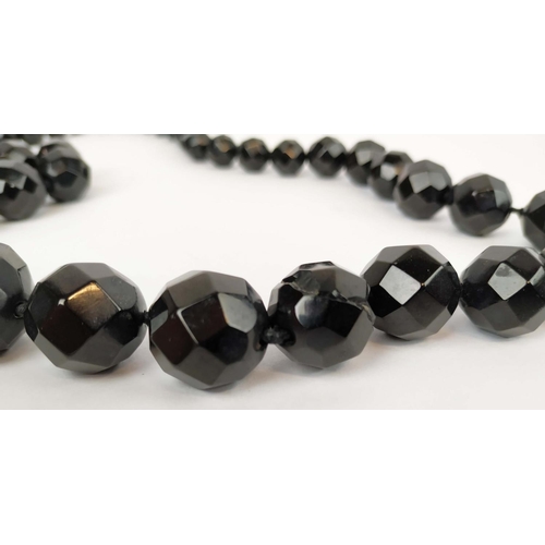 35 - A WHITBY JET SINGLE STRAND NECKLACE, fitted with 42 graduated faceted beads, 74cm long; together wit... 