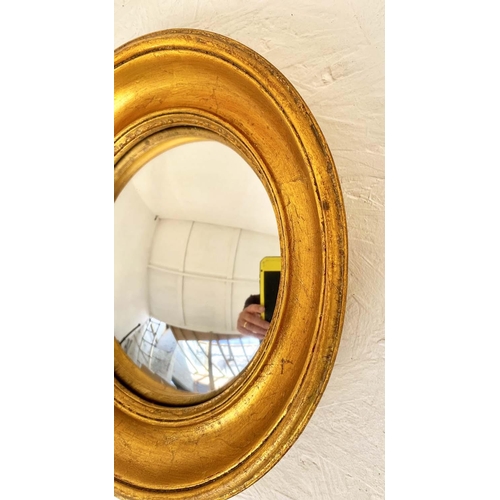 415 - CONVEX WALL MIRRORS, a set of twelve, Regency style, various shapes and sizes, gilt frames, largest ... 