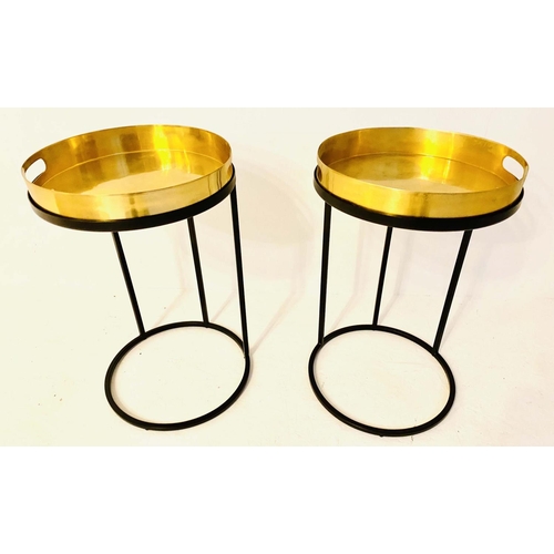 430 - TRAY TABLES, 57cm high, 36cm in diameter, a pair, the gilt metal trays raised on black bases. (2)