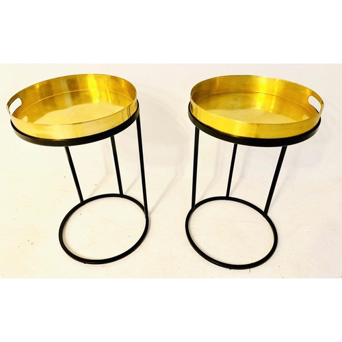 430 - TRAY TABLES, 57cm high, 36cm in diameter, a pair, the gilt metal trays raised on black bases. (2)