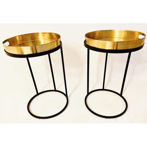 430 - TRAY TABLES, 57cm high, 36cm in diameter, a pair, the gilt metal trays raised on black bases. (2)