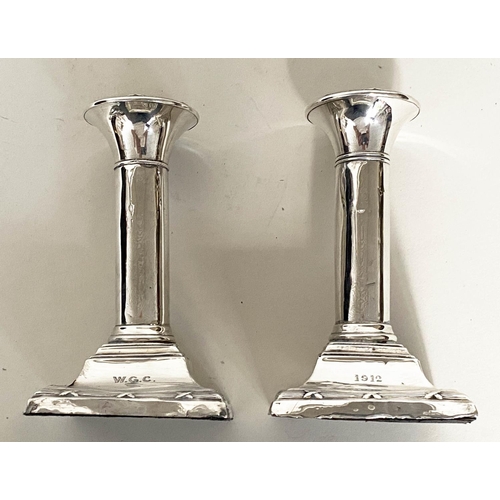 292 - CANDLESTICKS, a pair, Edward VII silver with square reeded bases Chester 1910, together with a pair ... 