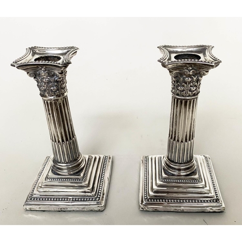 292 - CANDLESTICKS, a pair, Edward VII silver with square reeded bases Chester 1910, together with a pair ... 