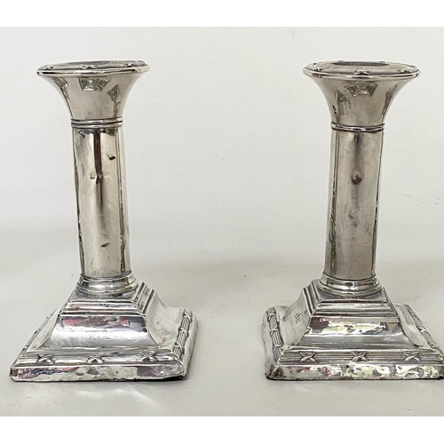 292 - CANDLESTICKS, a pair, Edward VII silver with square reeded bases Chester 1910, together with a pair ... 