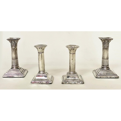 292 - CANDLESTICKS, a pair, Edward VII silver with square reeded bases Chester 1910, together with a pair ... 