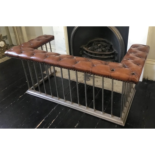 201 - CLUB FENDER, early 20th century brass studded tan leather, raised upon steel balustrade, 146cm W x 7... 