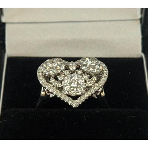 11 - AN 18CT WHITE GOLD DIAMOND DRESS RING, the head in the form of a heart, encrusted with round brillia... 