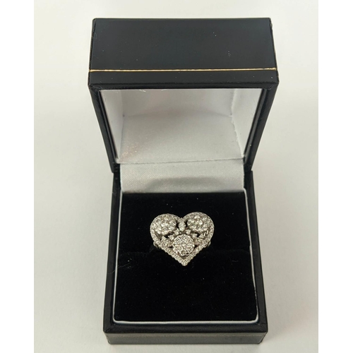 11 - AN 18CT WHITE GOLD DIAMOND DRESS RING, the head in the form of a heart, encrusted with round brillia... 