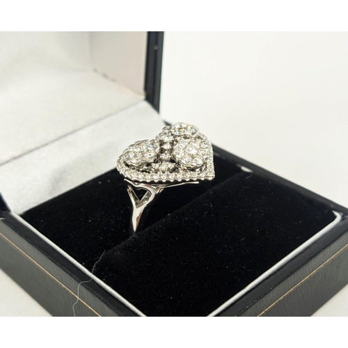 11 - AN 18CT WHITE GOLD DIAMOND DRESS RING, the head in the form of a heart, encrusted with round brillia... 