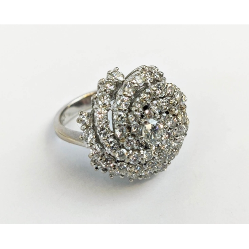 12 - AN 18CT WHITE GOLD DIAMOND SET DRESS RING, of spiral design, the central stone of approximately 0.33... 