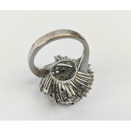 12 - AN 18CT WHITE GOLD DIAMOND SET DRESS RING, of spiral design, the central stone of approximately 0.33... 