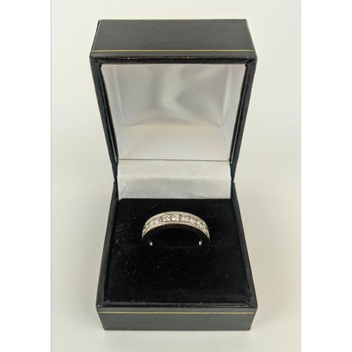 4 - A DIAMOND SET WHITE METAL ETERNITY RING, set with 24 round brilliant cut diamonds, channel set, each... 